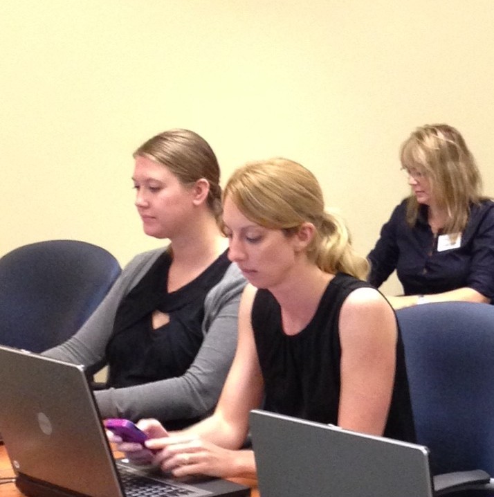 Members of the Pinellas Realtor Organization's office and professional staff being trained to use the mobile web system SavvyCard.